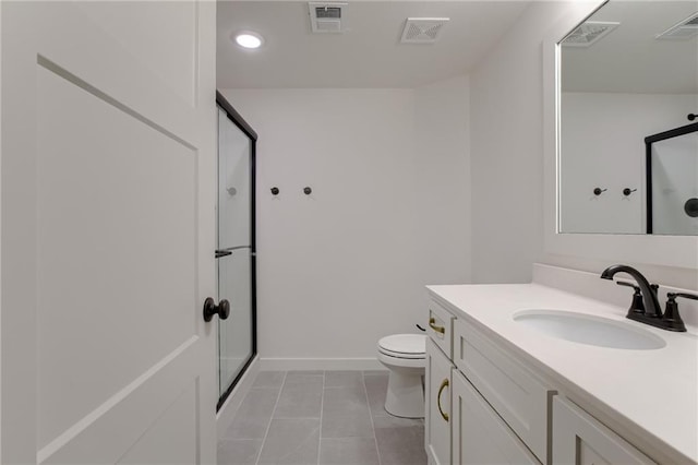 bathroom with toilet, vanity, tile patterned floors, and walk in shower