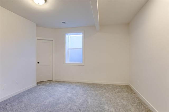 unfurnished room featuring light carpet