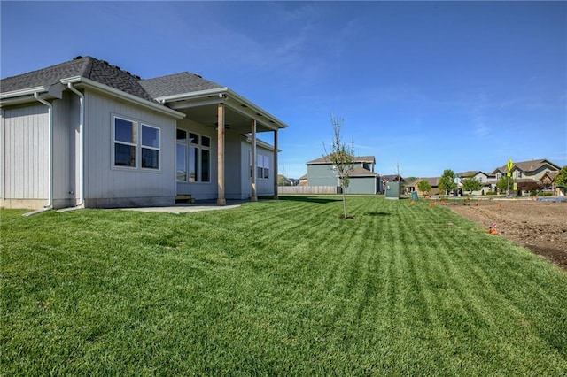 back of property featuring a lawn