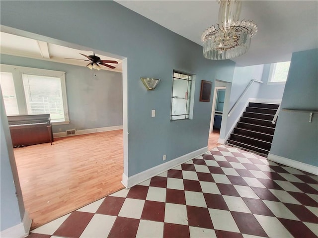 3518 Paseo Blvd, Kansas City, MO 64109 - entryway with stairway, a chandelier, tile patterned floors, baseboards, and ceiling fan