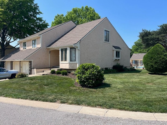 view of front of house with a front lawn and a garage