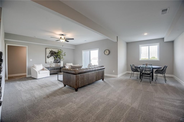 living room with ceiling fan and light colored carpet