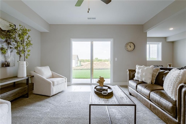 living room featuring ceiling fan and light colored carpet