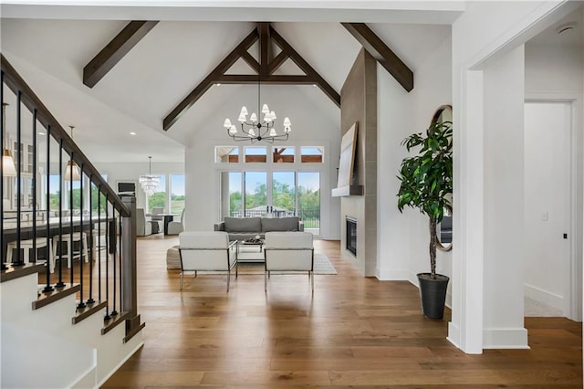 foyer featuring wood-type flooring, beamed ceiling, a chandelier, and high vaulted ceiling