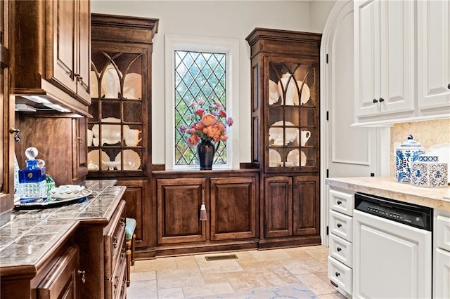 kitchen featuring white cabinets, dark brown cabinets, and dishwasher