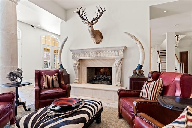 living room with a fireplace and light tile patterned flooring