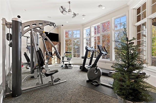 workout room featuring crown molding