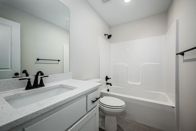 full bathroom with tile flooring, toilet, washtub / shower combination, and vanity