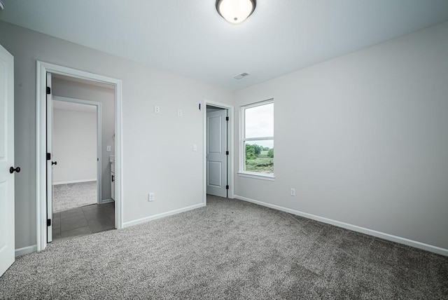 unfurnished bedroom with carpet floors