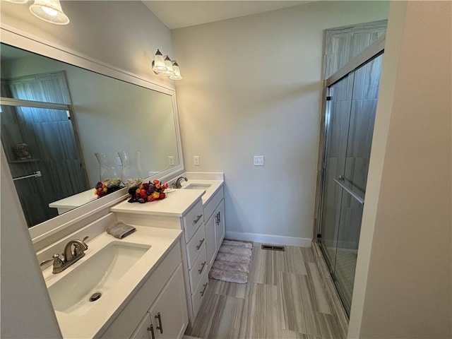 bathroom with an enclosed shower, tile floors, and vanity