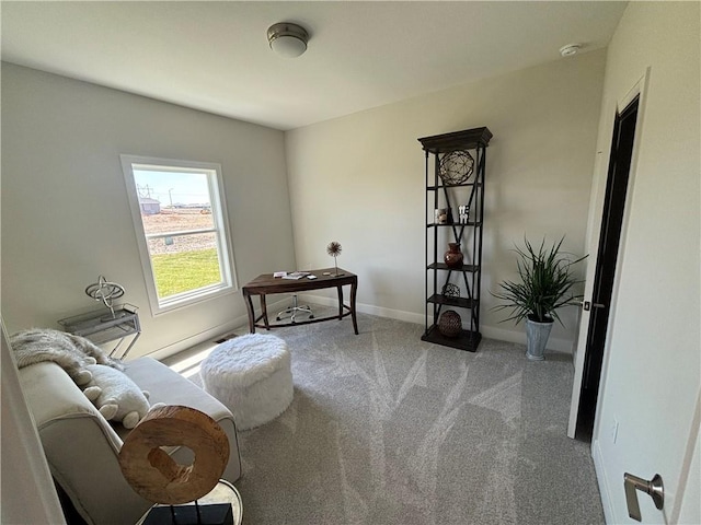 sitting room featuring light colored carpet