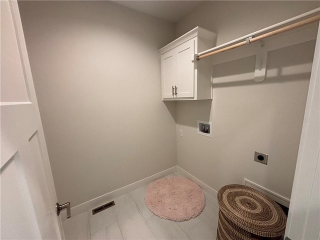 laundry area with cabinets, hookup for an electric dryer, light tile flooring, and washer hookup