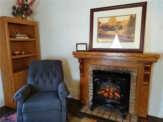 sitting room with dark hardwood / wood-style floors and a fireplace