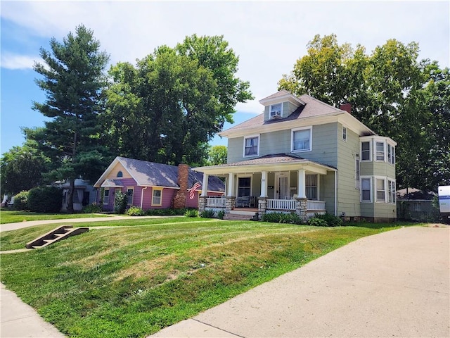 view of front of house with a front lawn and a porch