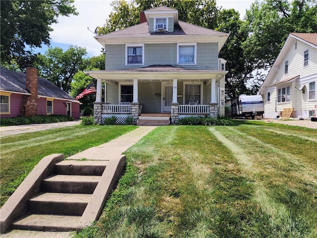 view of front facade with covered porch and a front lawn