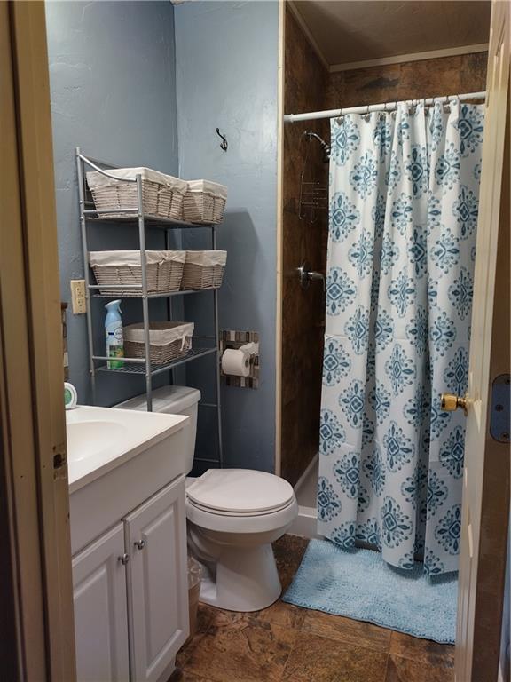 bathroom featuring toilet, tile floors, and vanity