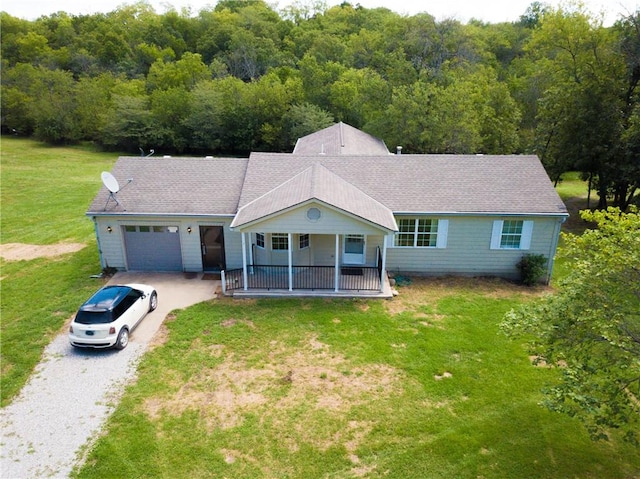 ranch-style house with a porch, a front lawn, and a garage