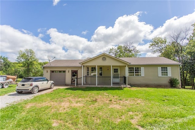 single story home featuring covered porch, a front yard, and a garage