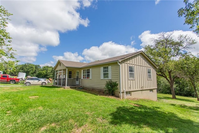 rear view of property with a lawn