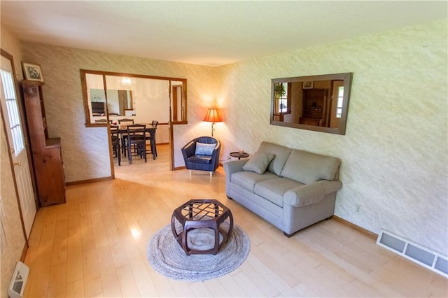 living room featuring a healthy amount of sunlight and light hardwood / wood-style floors