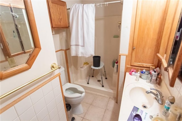 bathroom featuring tile flooring, a shower, toilet, and sink