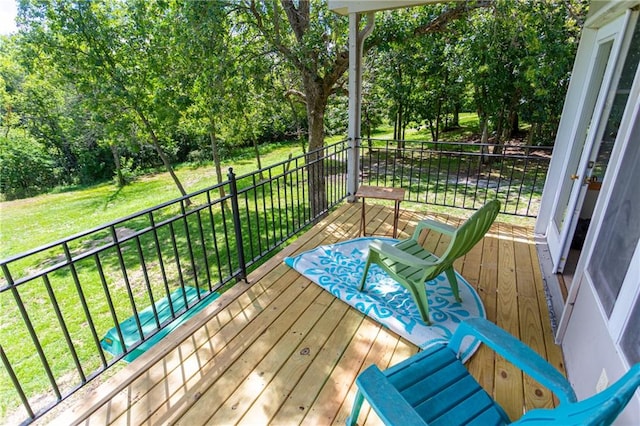 wooden deck with a lawn