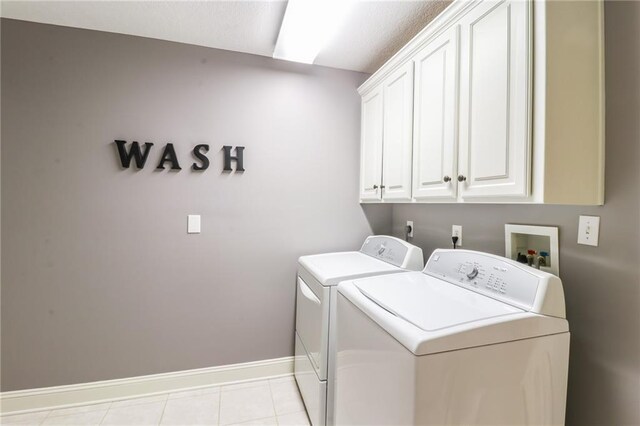 29800 E 65th St, Blue Springs, MO 64014 - laundry room with cabinet space, washing machine and dryer, baseboards, and light tile patterned floors