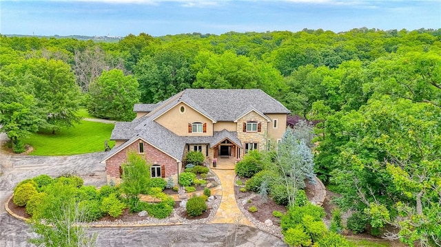 29800 E 65th St, Blue Springs, MO 64014 - traditional-style house featuring stone siding, stucco siding, and a view of trees