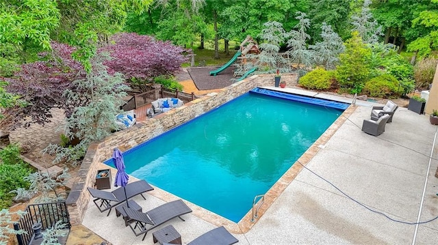 29800 E 65th St, Blue Springs, MO 64014 - view of swimming pool with a playground, a patio, and view of wooded area