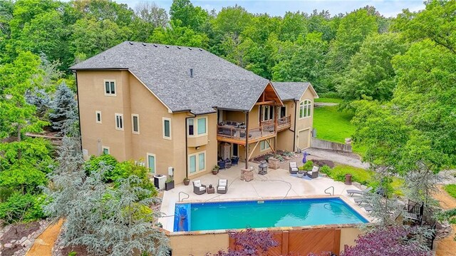 29800 E 65th St, Blue Springs, MO 64014 - back of house with stucco siding, a patio, a balcony, an outdoor pool, and central air condition unit