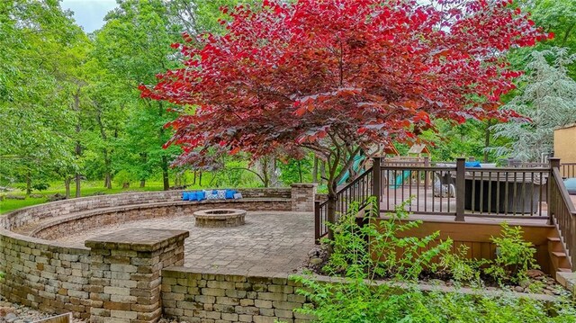 29800 E 65th St, Blue Springs, MO 64014 - view of patio with an outdoor fire pit, a wooden deck, and stairs