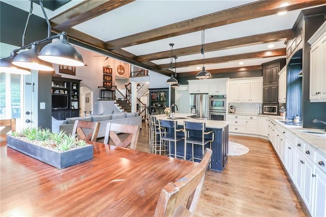 29800 E 65th St, Blue Springs, MO 64014 - dining area with light wood finished floors, beamed ceiling, and stairway