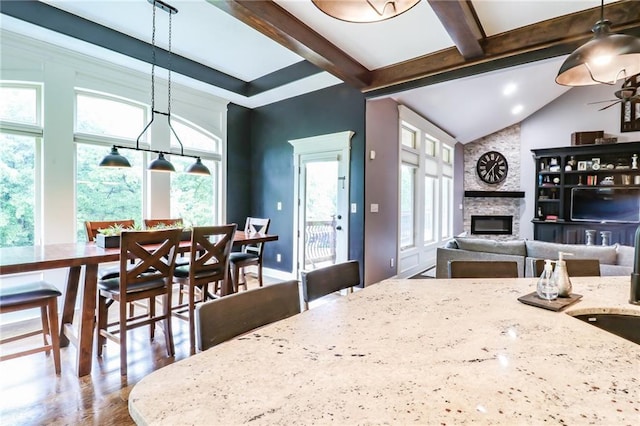 29800 E 65th St, Blue Springs, MO 64014 - kitchen featuring a fireplace, light stone counters, wood finished floors, hanging light fixtures, and a sink
