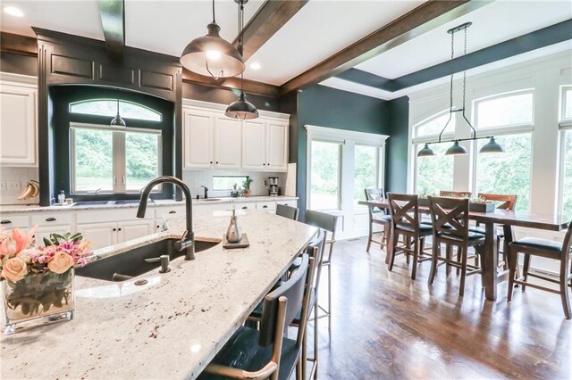 29800 E 65th St, Blue Springs, MO 64014 - kitchen with a sink, healthy amount of natural light, backsplash, a kitchen bar, and recessed lighting