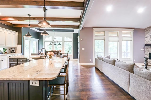 29800 E 65th St, Blue Springs, MO 64014 - kitchen with a sink, open floor plan, beam ceiling, light stone counters, and white cabinets