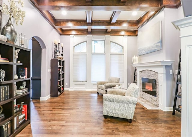 29800 E 65th St, Blue Springs, MO 64014 - living area with a fireplace with flush hearth, wood finished floors, beam ceiling, coffered ceiling, and baseboards