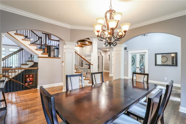 29800 E 65th St, Blue Springs, MO 64014 - dining area with ornate columns, arched walkways, wood finished floors, crown molding, and a chandelier