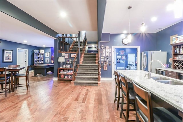 29800 E 65th St, Blue Springs, MO 64014 - kitchen with a sink, stainless steel refrigerator with ice dispenser, light stone countertops, light wood-style flooring, and recessed lighting