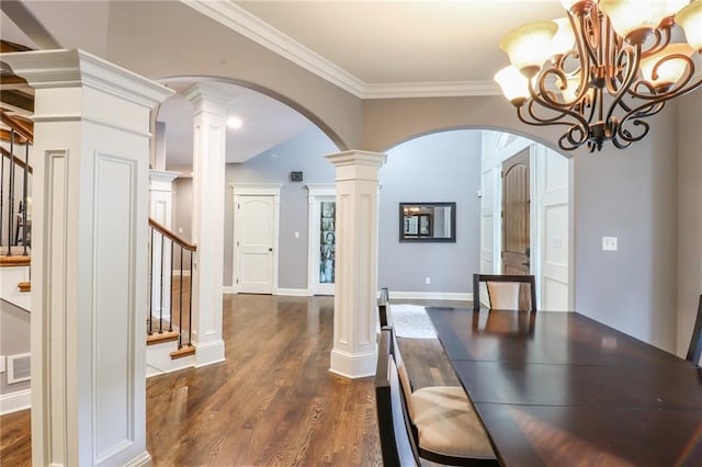 29800 E 65th St, Blue Springs, MO 64014 - unfurnished dining area featuring arched walkways, decorative columns, stairs, dark wood-style flooring, and crown molding