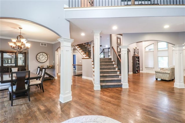 29800 E 65th St, Blue Springs, MO 64014 - entrance foyer featuring arched walkways, a towering ceiling, stairs, wood finished floors, and ornate columns