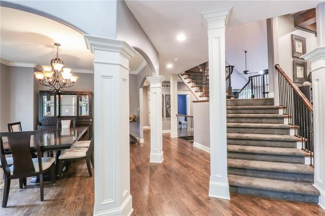 29800 E 65th St, Blue Springs, MO 64014 - staircase with ornate columns, wood finished floors, a chandelier, crown molding, and recessed lighting