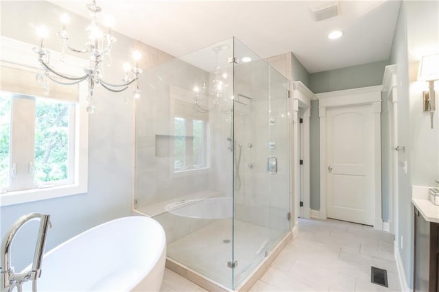 29800 E 65th St, Blue Springs, MO 64014 - bathroom with a chandelier, a soaking tub, a stall shower, vanity, and baseboards