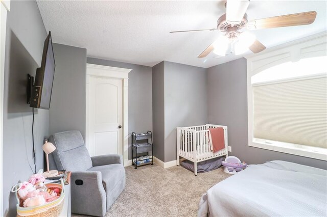29800 E 65th St, Blue Springs, MO 64014 - bedroom with carpet, a crib, a ceiling fan, and baseboards