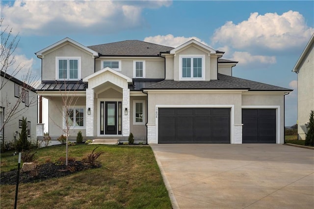 view of front of property featuring a front yard and a garage