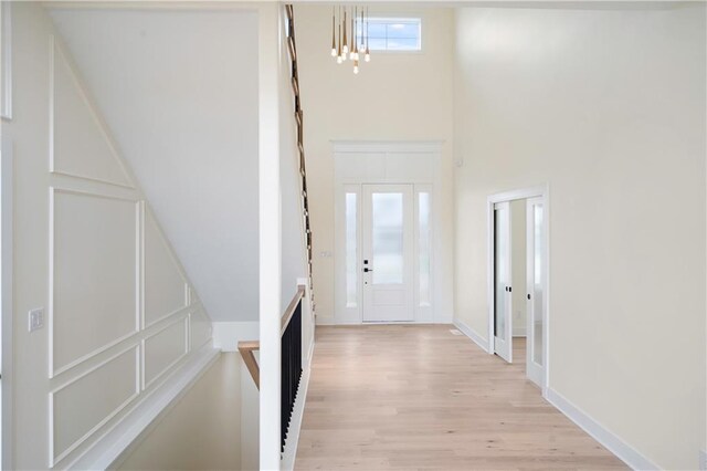 entrance foyer featuring a high ceiling and light wood-type flooring