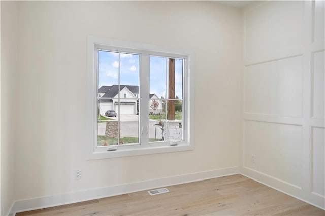 unfurnished room with light wood-type flooring