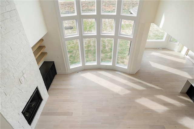 unfurnished living room featuring light hardwood / wood-style floors and a fireplace