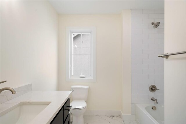 full bathroom featuring toilet, tiled shower / bath, and vanity