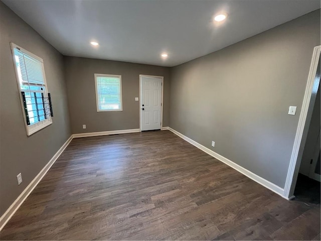 unfurnished room featuring dark wood-type flooring