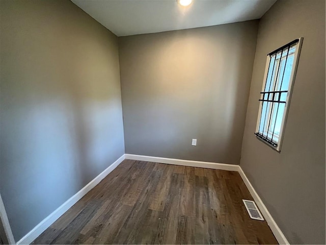 unfurnished room featuring dark hardwood / wood-style flooring